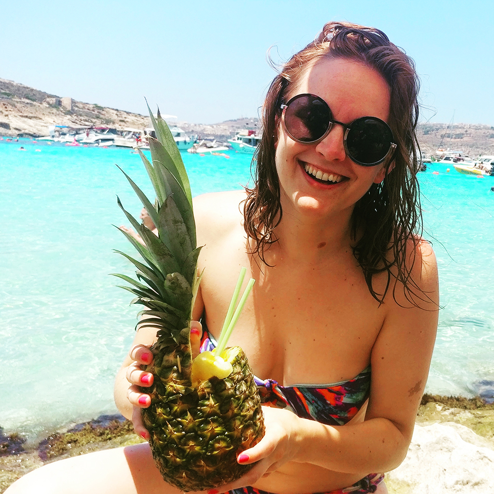 Drink a cocktail from a pineapple at Blue Lagoon, Comino - Best beaches in Malta | Aliz’s Wonderland