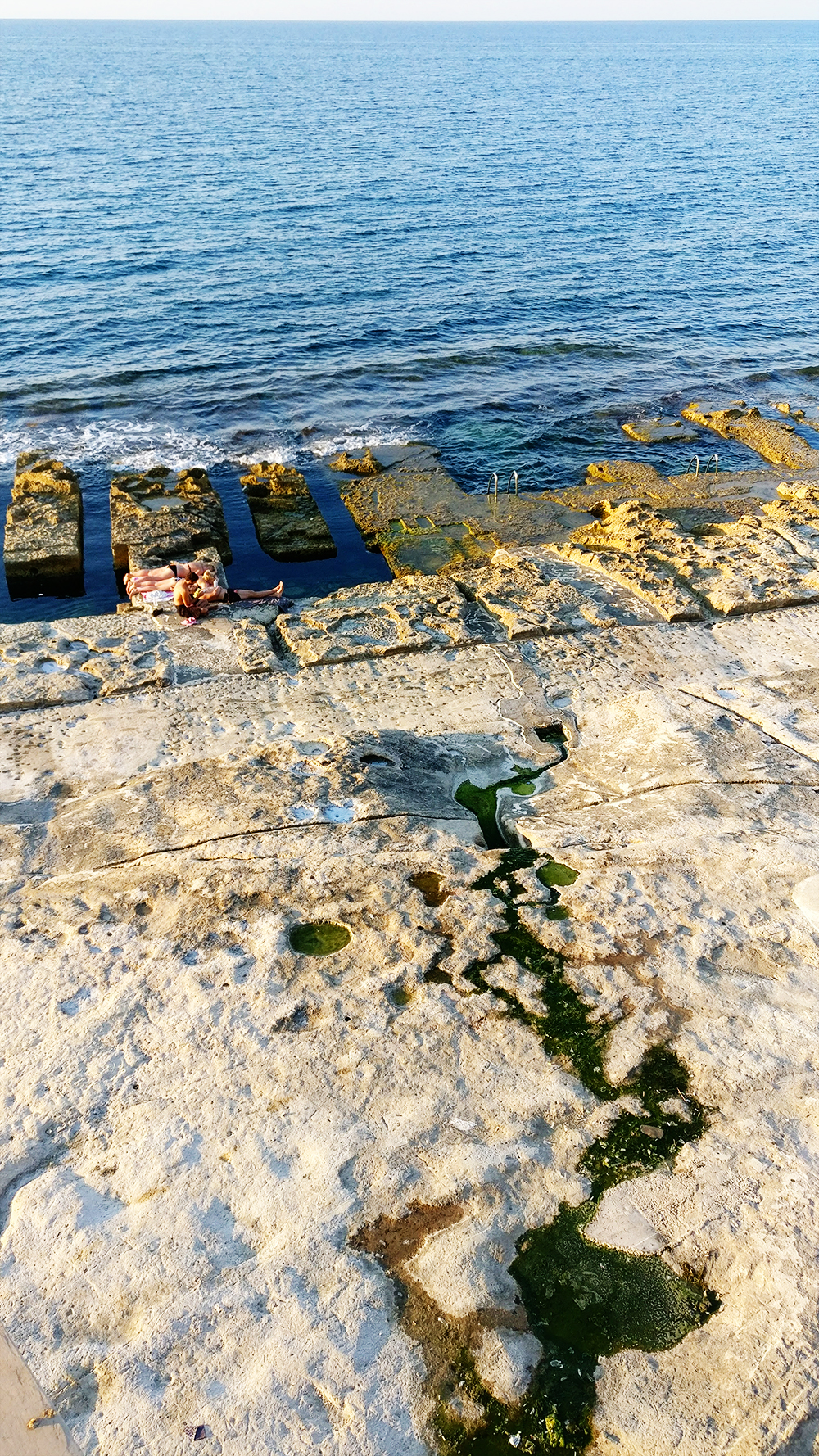 The rocky Fond Ghadir beach with small square pools in Sliema - Best beaches in Malta | Aliz’s Wonderland